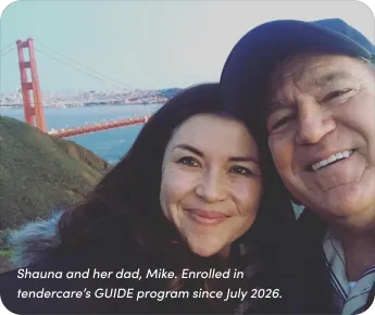 A caregiver and their loved one smiling outdoors